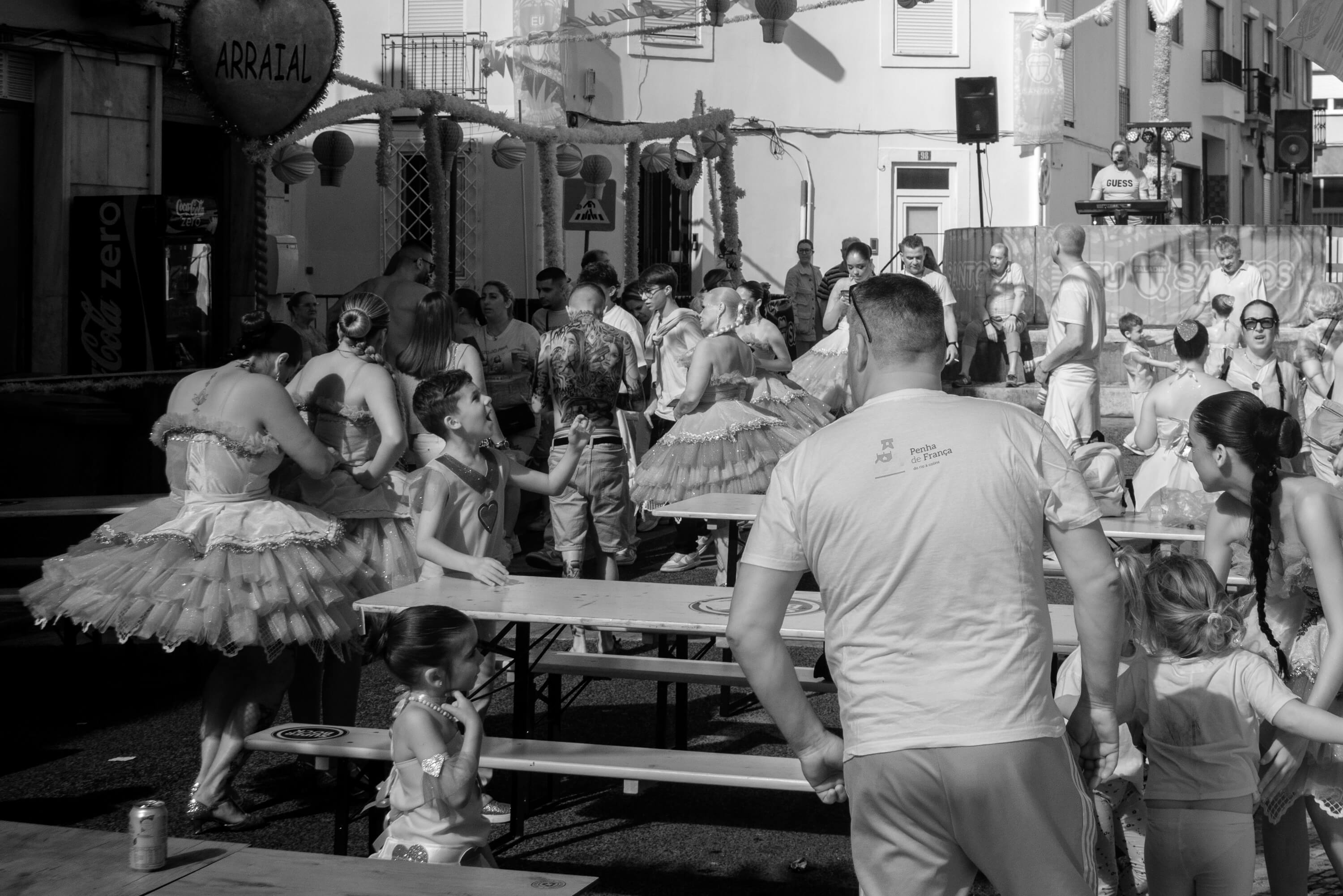 A street has been taken over for a block party. People are getting ready for the festivities.
